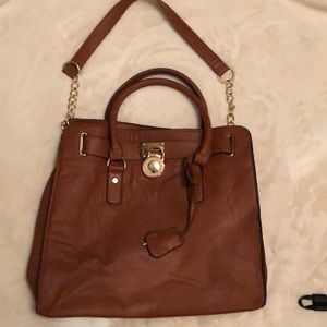 Brown Michael Kors purse oriented with gold trim